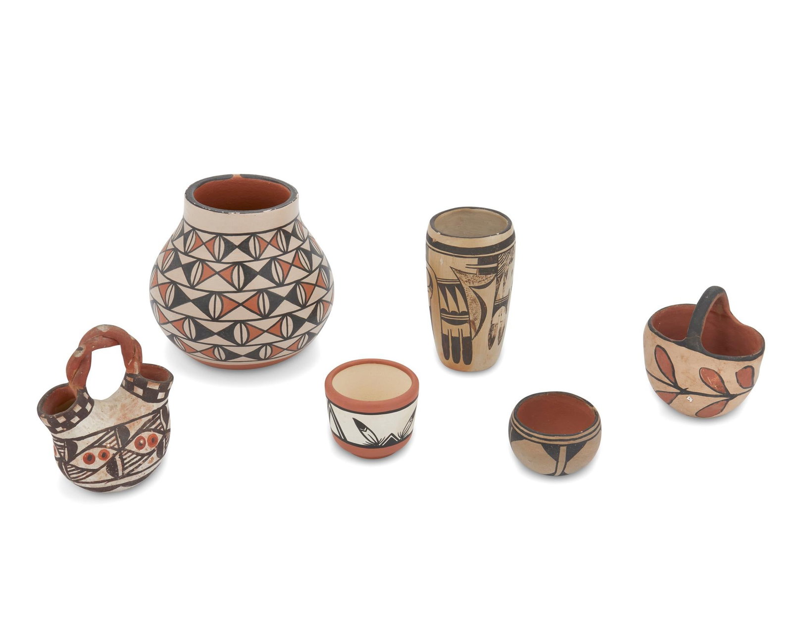 A group of Puebloan pottery vessels: A group of Puebloan pottery vessels 20th century; Southwestern United States Largest marked: Vickey T. Calabaza / S.D.P.; second smallest marked: Tegua by [indecipherable] Comprising six Hopi and Sant