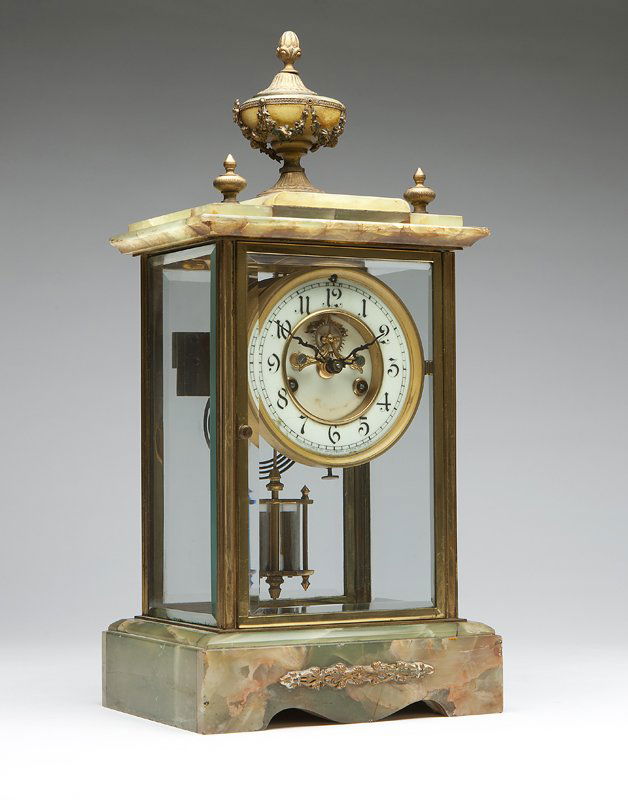 A Waterbury crystal regulator mantle clock: Circa 1900, marked to dial ''Manufactured by Waterbury Clock Co. USA'', marked to back plate ''Waterbury Clock Co. USA'', the white porcelain open escapement dial with black Arabic numerals and minute