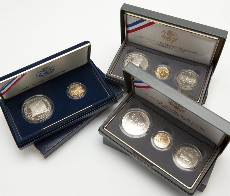 Three proof sets of US commemorative coins: Comprising two sets of United States Mount Rushmore Anniversary coins, 1991, and one set of United States Constitution coins, 1987; each Rushmore set comprising: one gold five dollar, West Point Mint,
