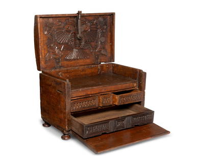 A Mexican carved wood chest of drawers: A Mexican carved wood chest of drawersEarly 19th centuryThe chest with wrought iron hardware and hinged top opening to reveal a carved two-headed bird centering two similar birds amidst a foliate scen