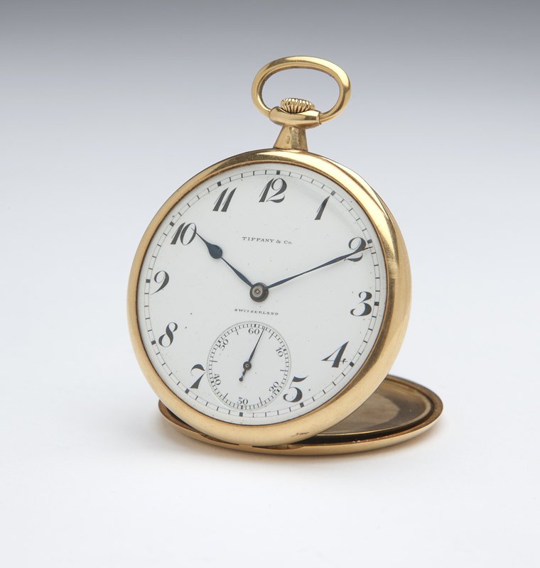 A Tiffany and Co. by Patek Philippe pocket watch: The circular white porcelain dial with black Arabic hour chapters and minute division track, signed in black 'Tiffany & Co. Switzerland', attached to an 18 jewel stem wind and set movement, signed 'Ti