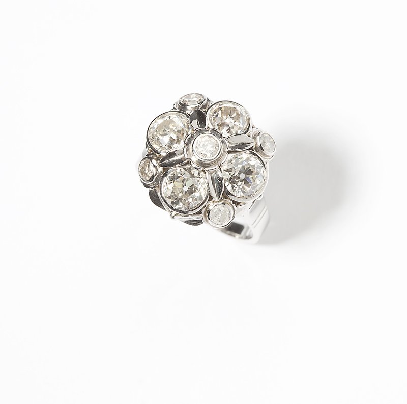 A diamond and white gold ring: Stamped for Hans Schott, mounted in 14K white gold, the four old European-cut diamonds further accented with 5 old-cut diamonds totaling approximately 3.20 cts, graded I-J-K-L color and SI-I clarity,