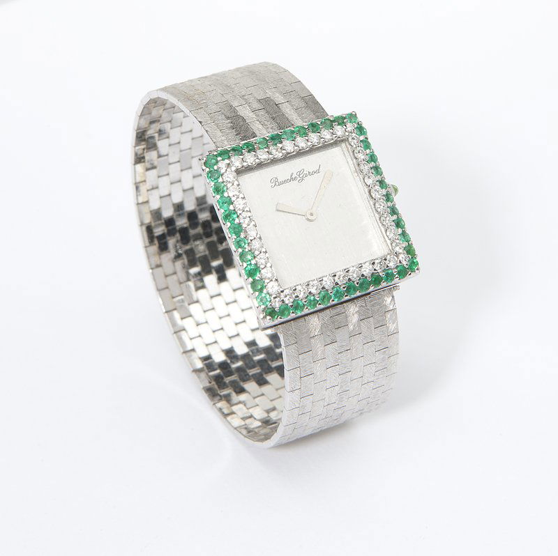 A diamond and emerald wristwatch, Bueche Girod: The square brushed silver dial signed 'Bueche Girod', attached to a 17 jewel movement adjusted 5 positions signed 'Bueche Girod', within an 18K white gold square case with inset diamonds and emeralds