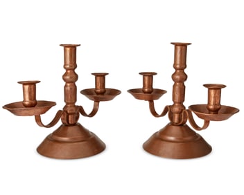 A pair of copper candlesticks