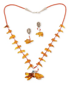A Jeff Tsalabutie Zuni carved amber fetish necklace
