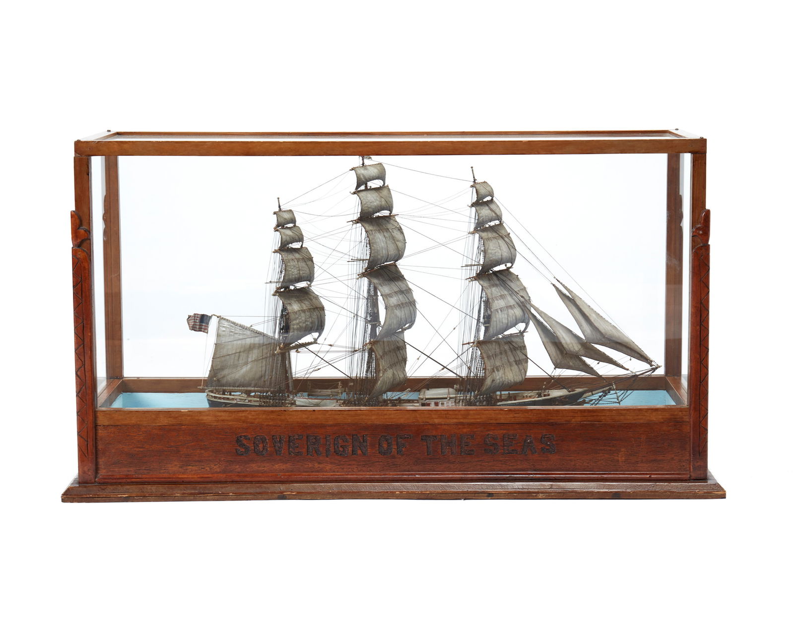 A ship's model of the "Sovereign of the Seas NY": A ship's model of the "Sovereign of the Seas NY"Early 20th centuryThe carved and painted wood three-masted clipper model ship depicted fully rigged in full sail, housed within a custom glaze