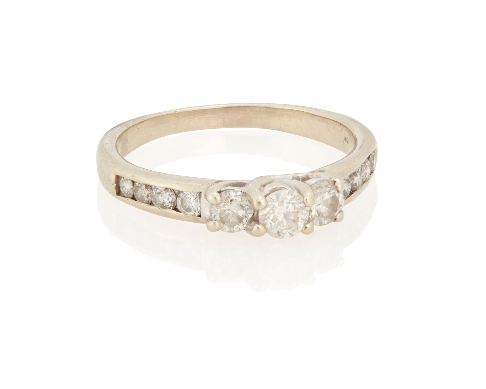 A Diamond Ring: A Diamond RingCentering a round brilliant-cut diamond highlighted by 5 round brilliant-cut diamonds on each side weighing a total of approximately .65 carat, set in 10K white gold3.3 grams grossRing S