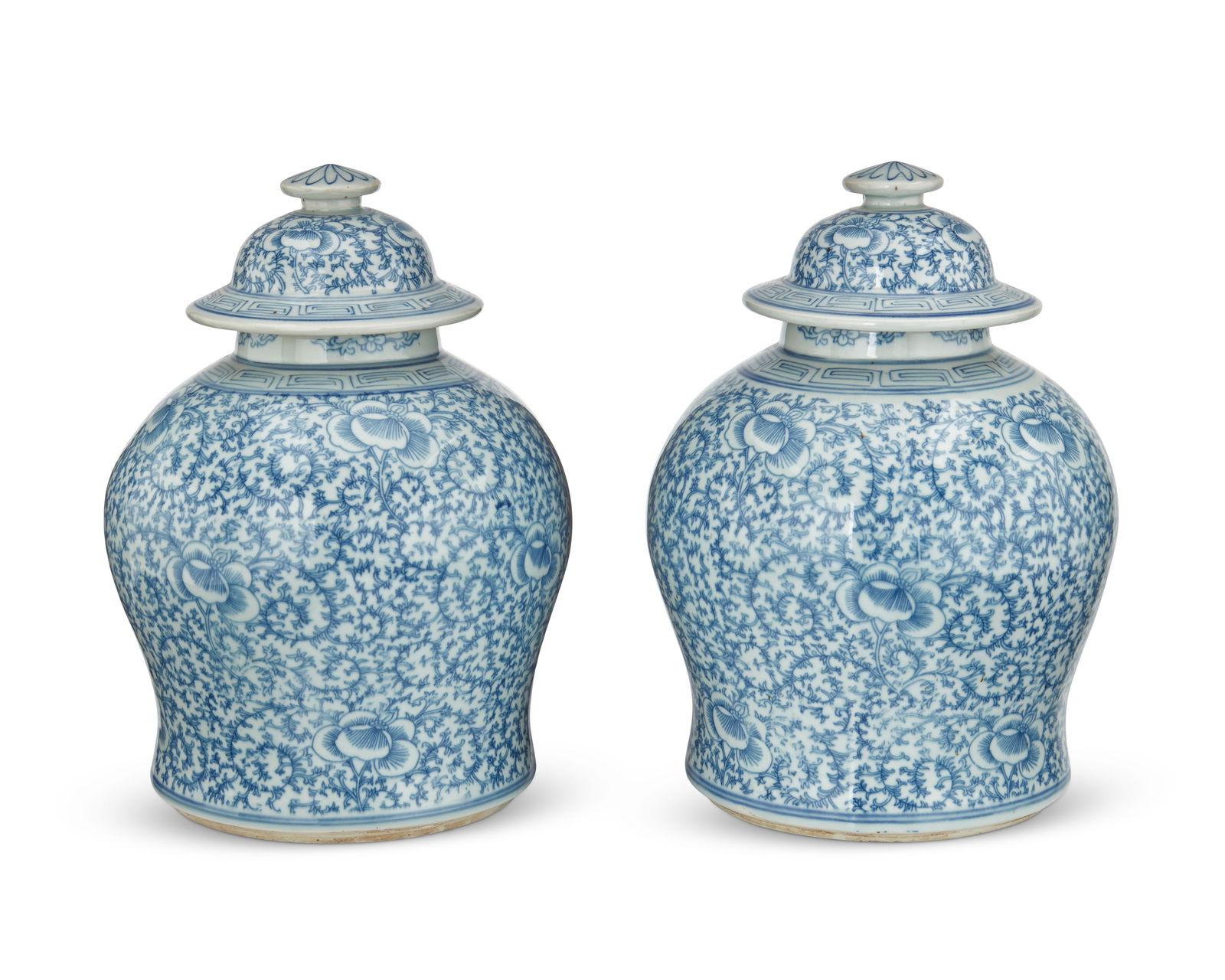 A pair of Chinese blue and white porcelain temple jars: A pair of Chinese blue and white porcelain temple jars20th centuryEach unmarkedEach lidded jar with all-over ornate vine and lotus scroll motifs and meandering motif banding to the shoulder and lid, r