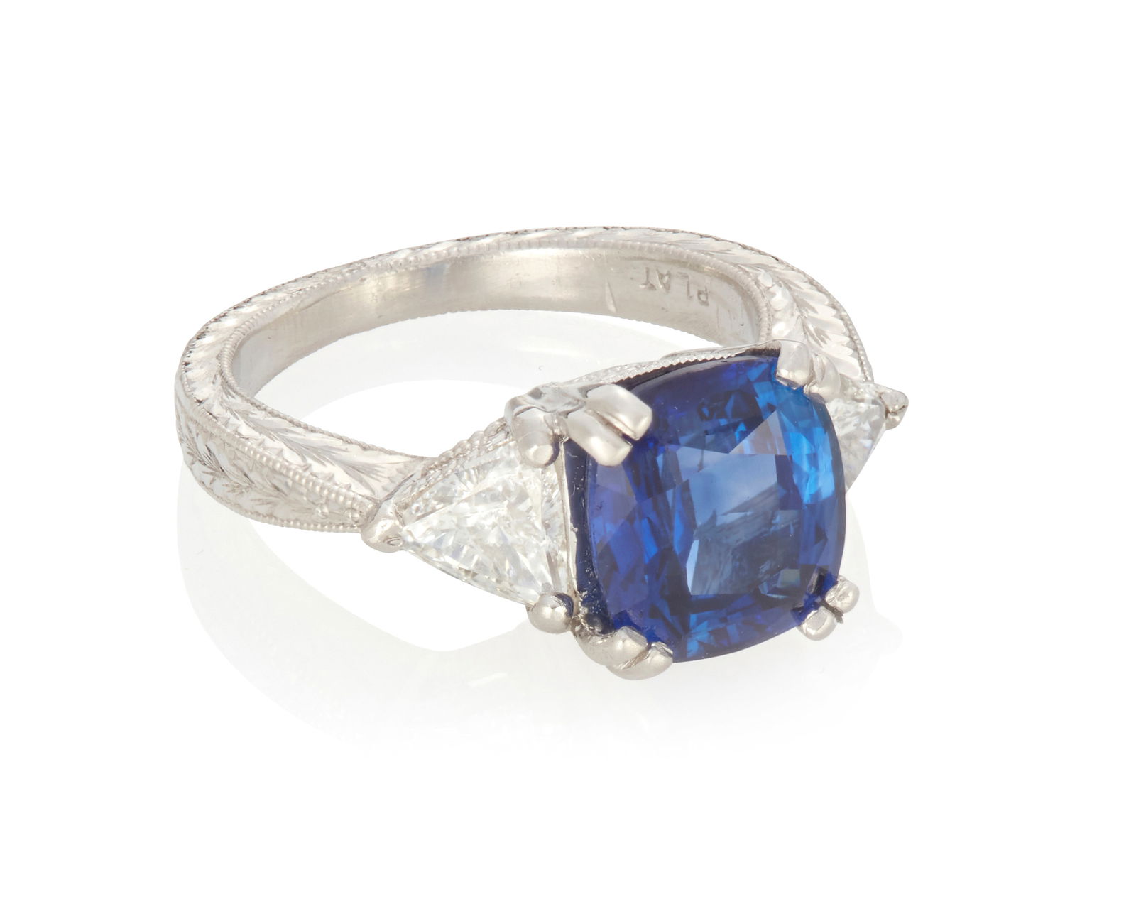 A Sapphire and Diamond Ring: A Sapphire and Diamond RingSet with a cushion-shaped sapphire measuring 8.84 mm x 8.14 mm x 5.25 mm and weighing 3.56 carats, accented by a pair of trillion-shaped diamonds weighing a total of approxi