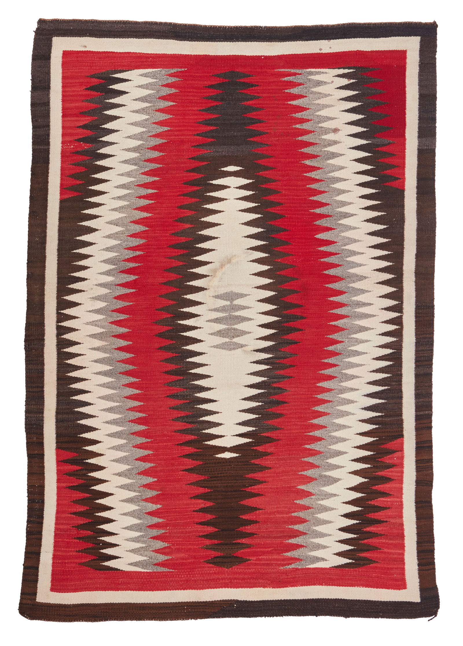 A Navajo regional rug: A Navajo regional rugMid-20th century, DineWith a radiating serrated diamond motif woven in red, cream, grey and dark brown wool61" H x 41.5" W