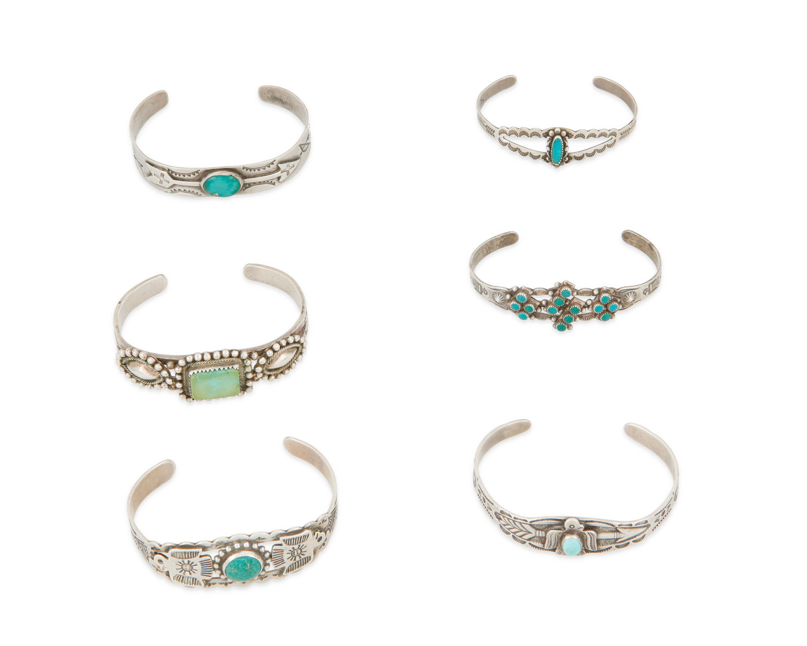 A group of Southwest silver and stone set cuff bracelets: A group of Southwest silver and stone set cuff braceletsMid-20th centuryFour marked for sterling; one further stamped: MaiselsComprising six sterling silver narrow cuff bracelets, each with set turquo