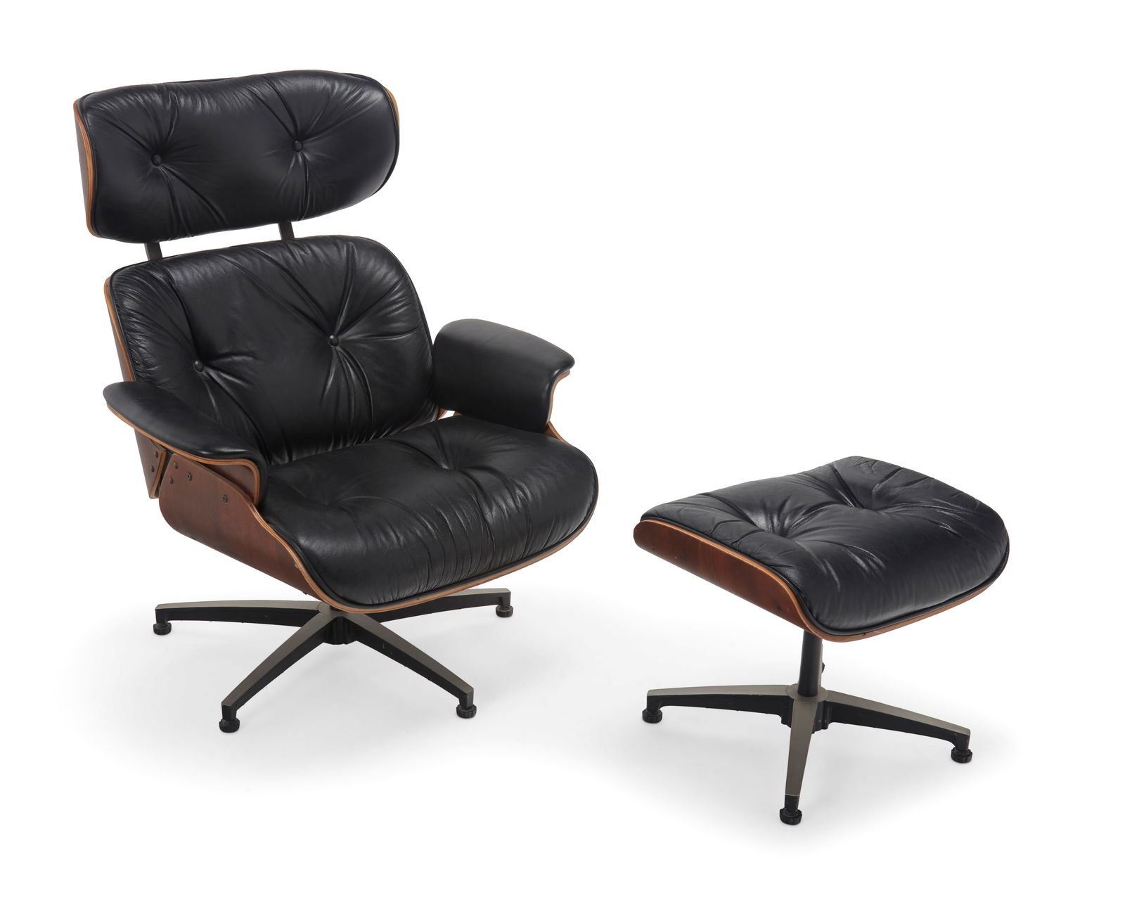 An Eames-style lounge chair and ottoman: An Eames-style lounge chair and ottomanLate 20th centuryWith sticker to chair underside: Plycraft Inc. / Designed by Lou AppThe molded plywood swivel recliner chair after the Eames lounge chair for He
