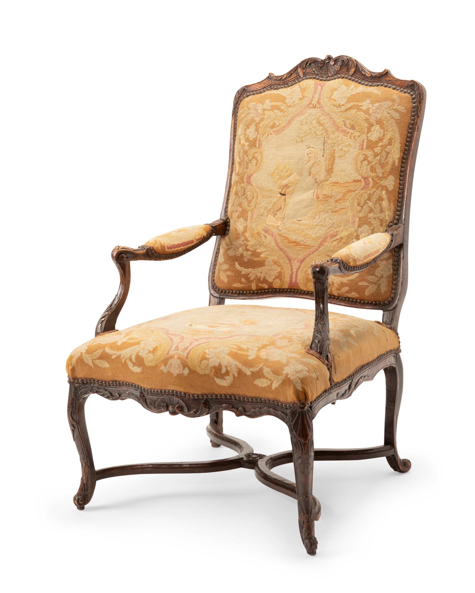A French Louis XV-style armchair: A French Louis XV-style armchairLate 19th centuryThe carved wood carcass with rocaille motifs and needlepoint upholstery depicting Diana with her hound surrounded by nail head trim42" H x 27"