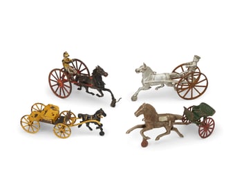 A group of cast iron horse-drawn toys