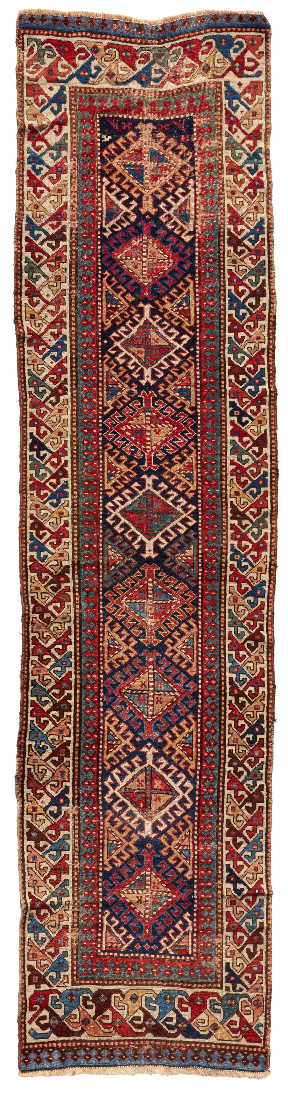 A Kazak runner: A Kazak runnerMid-20th centuryWool on wool foundation11' 6.5" L x 3' W