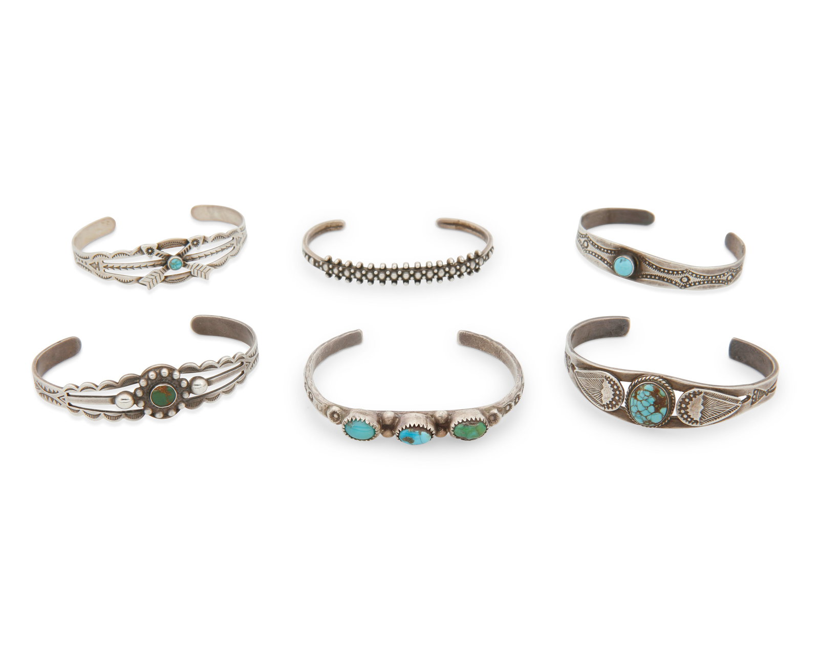 A group of Fred Harvey silver and turquoise cuff bracelets: A group of Fred Harvey silver and turquoise cuff braceletsEarly/mid-20th centuryOne marked for sterlingSix narrow silver cuffs, five with set turquoise, and all in various styles and sizes, with motif