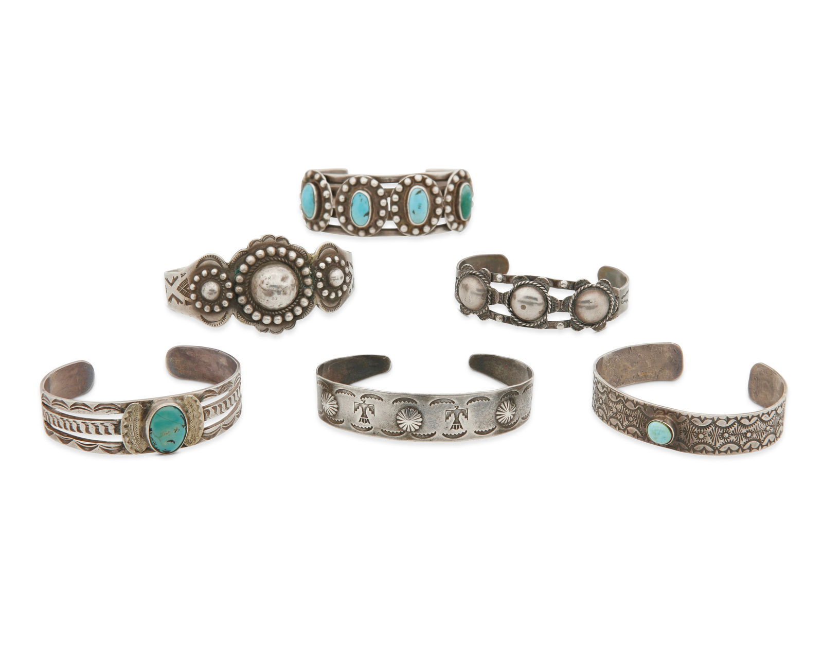 A group of Southwest silver cuff bracelets: A group of Southwest silver cuff braceletsMid-20th centuryOne marked for sterlingComprising six silver cuffs, including three with set turquoise, one a four wire cuff with four turquoise cabochon plaq