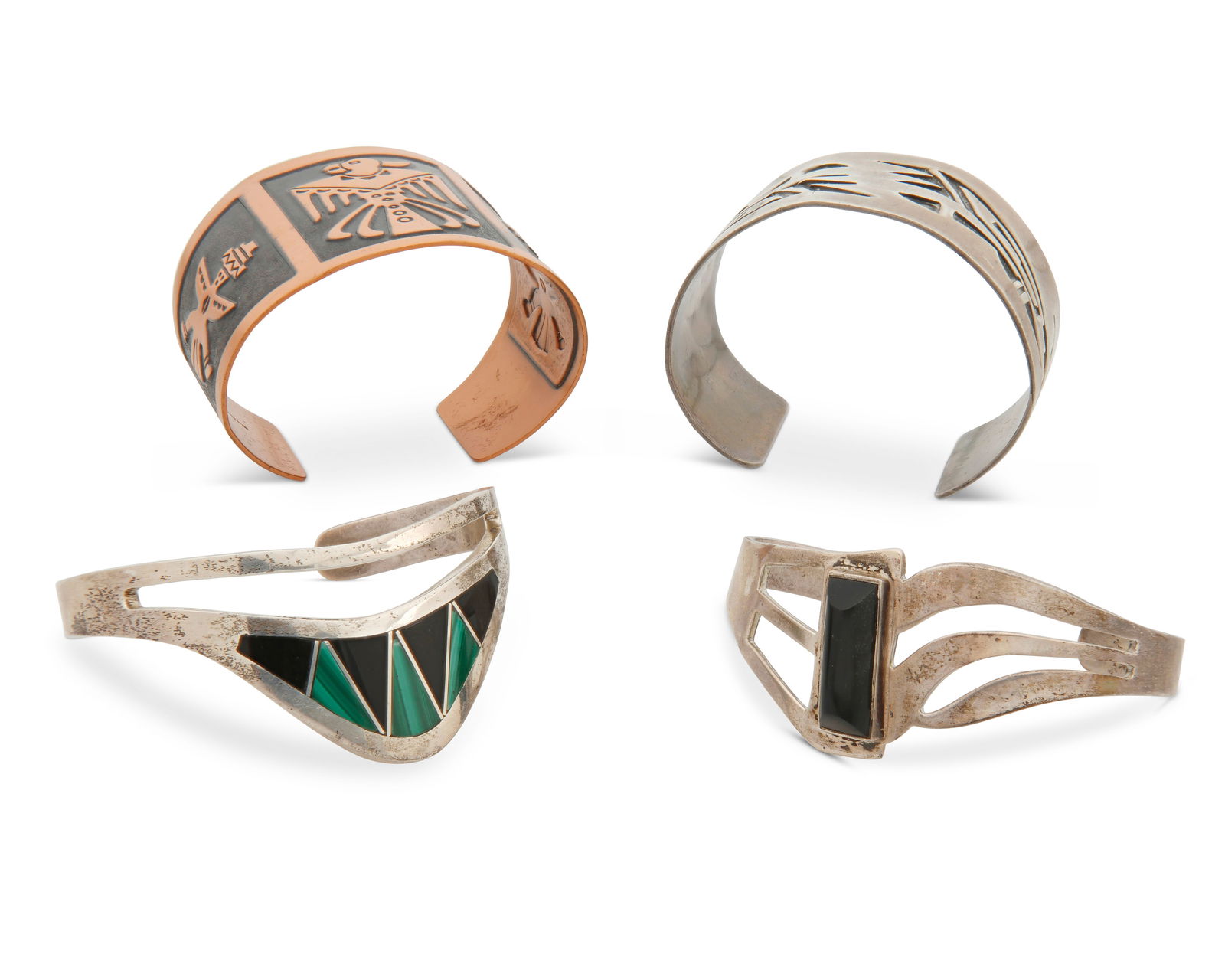 A group of Southwest-style jewelry: A group of Southwest-style jewelryMid/late 20th centuryTwo marked for Mexico and for sterling; one marked: CopperFour cuffs comprising a silver overlay cuff with Southwest motifs, a copper overlay cuf