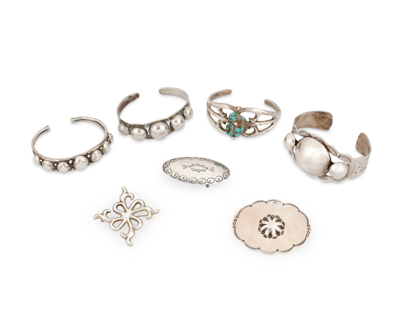A group of Southwest silver jewelry: A group of Southwest silver jewelryLate 20th centuryBuckle marked: J. Johnson [likely Janice Johnson, Navajo/Dine) / SterlingComprising three silver cuff bracelets of various sizes, each with applied