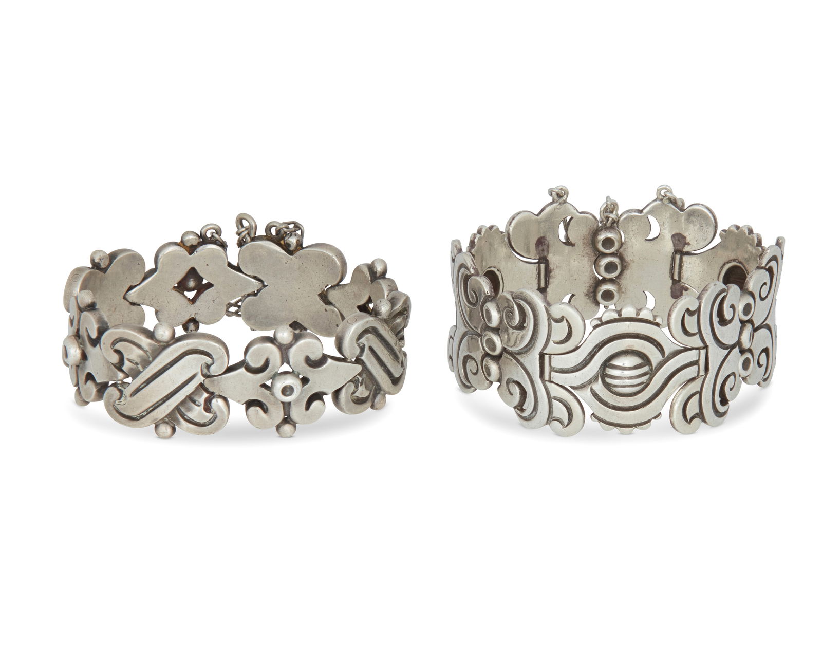 Two Hector Aguilar Mexican silver link bracelets: Two Hector Aguilar Mexican silver link braceletsHector Aguilar (1905-1986)Circa 1940-1945; Taxco, MexicoEach stamped: HA [conjoined] / Taxco / 940Twp sterling silver bracelets, one with chunky X-form