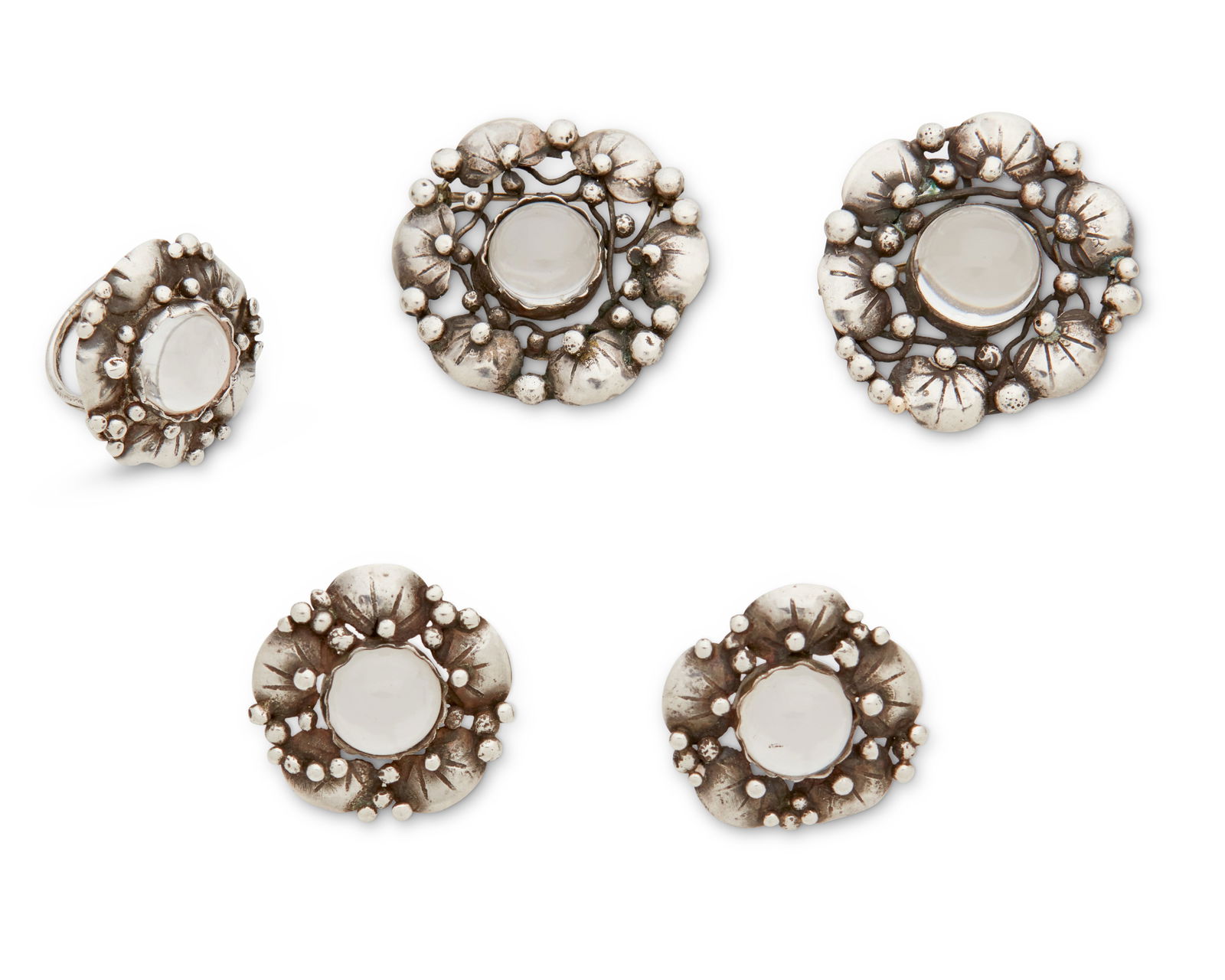 A set of Mary Gage sterling silver "Lily pad" jewelry: A set of Mary Gage sterling silver "Lily pad" jewelryMary Gage (1898-1993)Mid-20th centuryFour foliate works in sterling silver and set rock crystal featuring applied lilypad motifs and scat