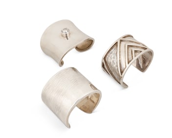 A group of sterling silver cuff bracelets