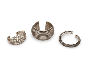 A group of sterling silver cuff bracelets