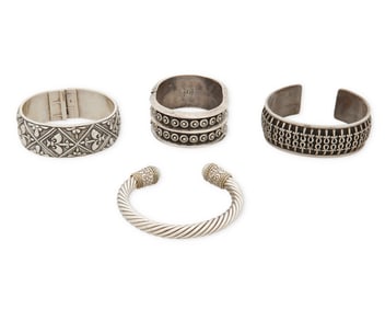 A group of silver bracelets