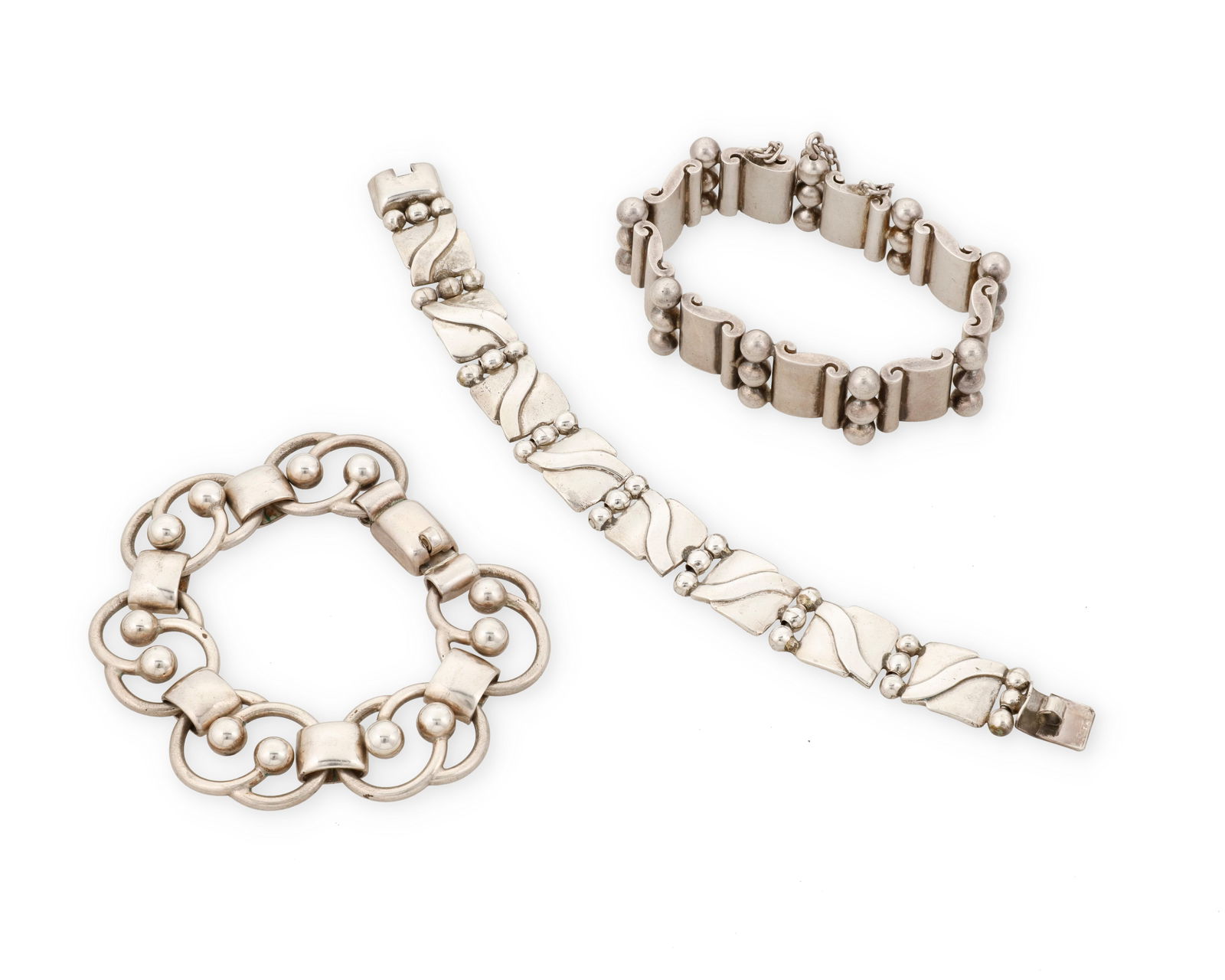 A group of Hector Aguilar Mexican silver link bracelets: A group of Hector Aguilar Mexican silver link braceletsHector Aguilar (1905-1986)Circa 1940-1945, 1953-1962; Taxco, MexicoEach stamped: HA [conjoined] / Taxco / 940; further variously stamped: [Eagle