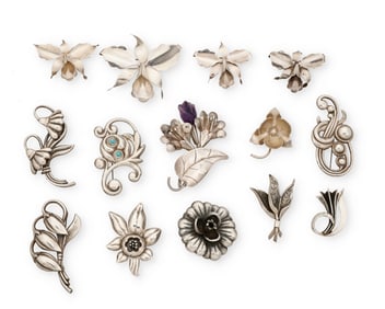 A large group of Mexican silver brooches