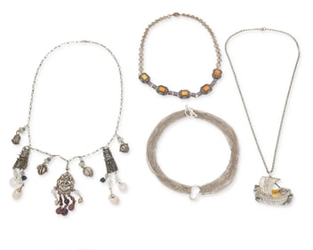 A group of silver necklaces