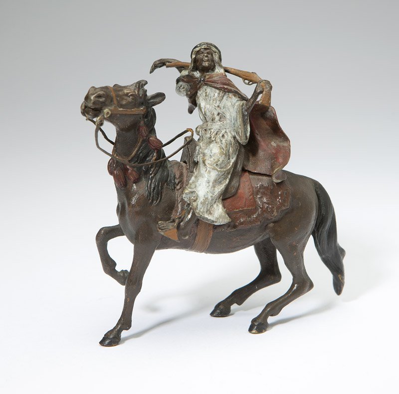 A Franz Bergman cold-painted bronze horseman: Late 19th / early 20th century, Austrian, the underside of horse with foundry mark and further marked ''Geschutzt'' and ''5724'', further marked ''5724'' to underside of cape, depicting an Arab on hor