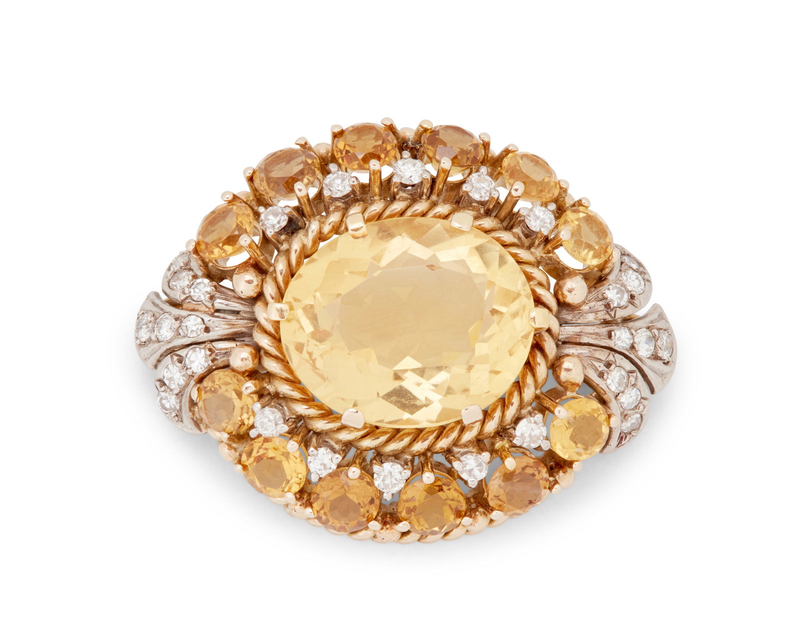 A 14K Bi-Color Gold, Citrine and Diamond Brooch: A 14K Bi-Color Gold, Citrine and Diamond BroochCentering an oval citrine weighing approximately 12.50 carats, set in an ornate frame accented with twelve round citrines and twenty-eight single-cut dia