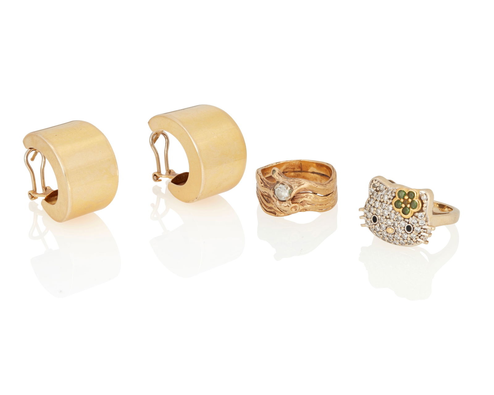 A Group of Gold Jewelry: A Group of Gold JewelryIncluding a pair of 14k high polish gold earrings, a 14k gold ring featuring an organic design with colorless stone and a Hello Kitty ring set with round diamonds and tsavorite