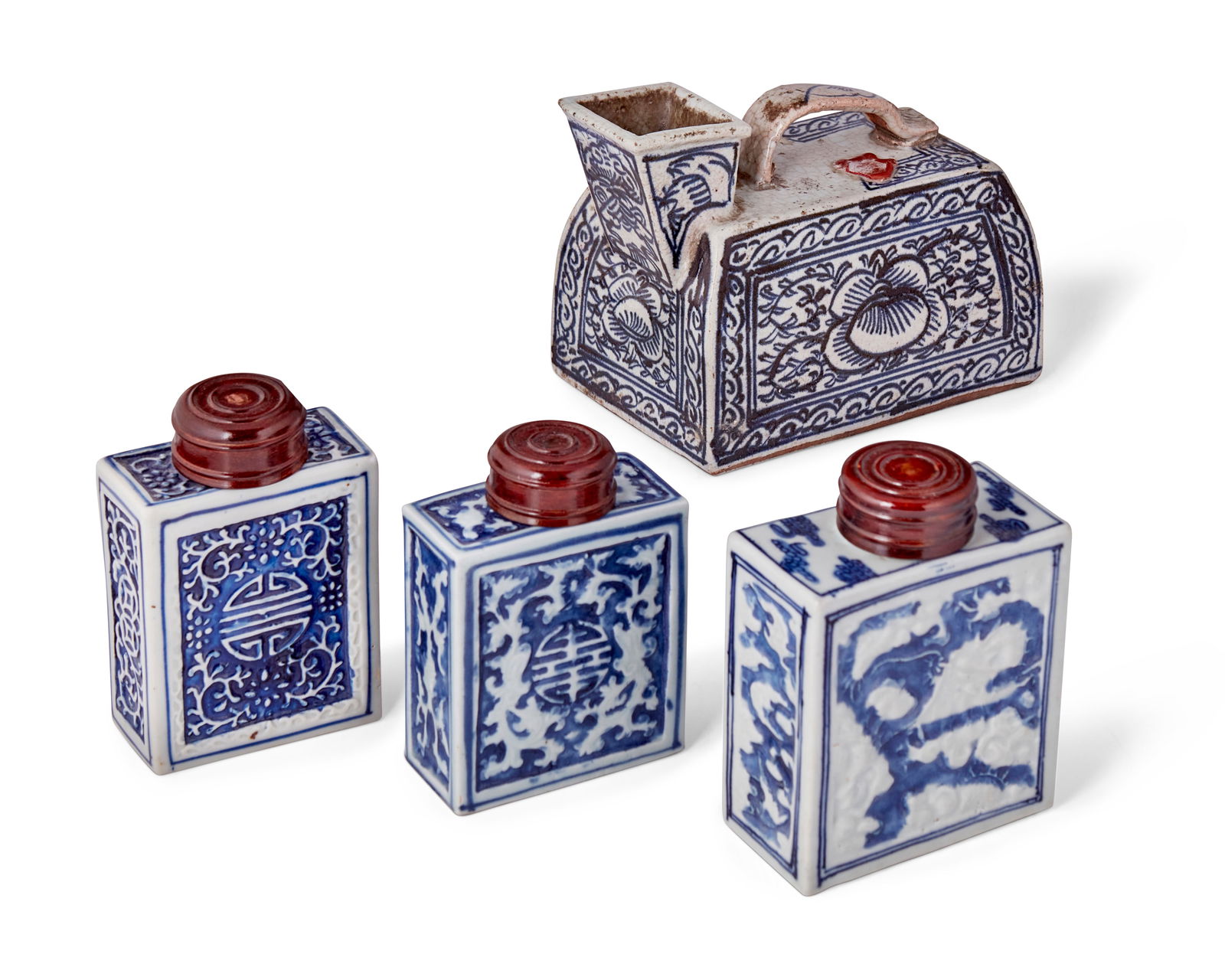 Four Chinese blue and white porcelain vessels: Four Chinese blue and white porcelain vessels19th/20th centuryUrinal marked in wax seal bearing Kanji charactersComprising three rectangular flasks featuring medallion and cloud motifs with carved and