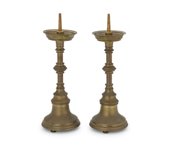 A pair of Continental brass prickets