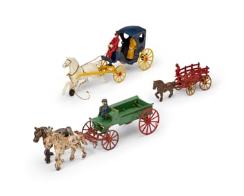 A group of Kenton cast iron horse-drawn wagon toys