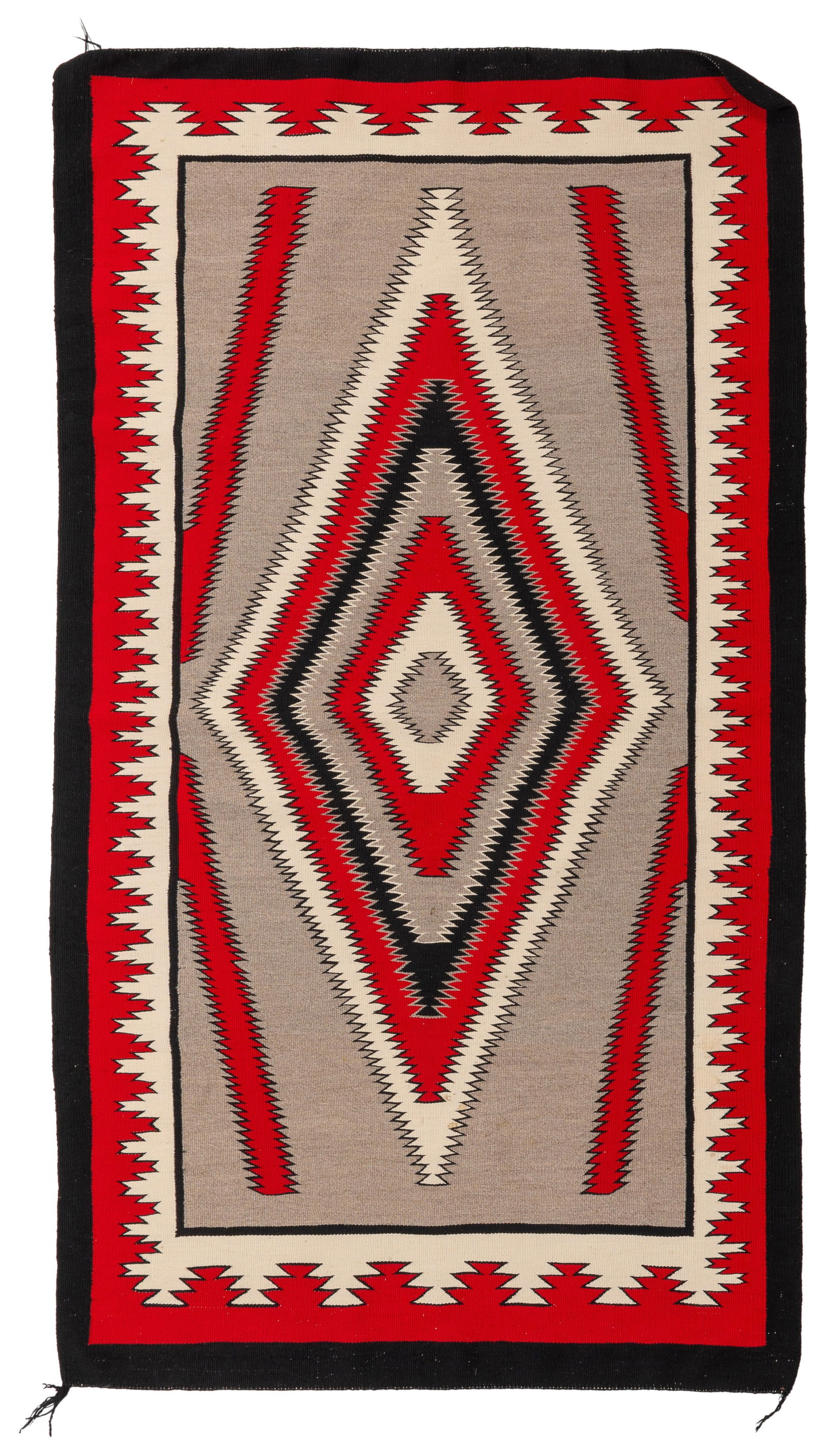A Navajo regional rug: A Navajo regional rugLate 20th century, DineWoven in red, cream, black, and grey wool, depicting a central radiating serrated diamond motif in an elaborate geometric border73" H x 41.5" W
