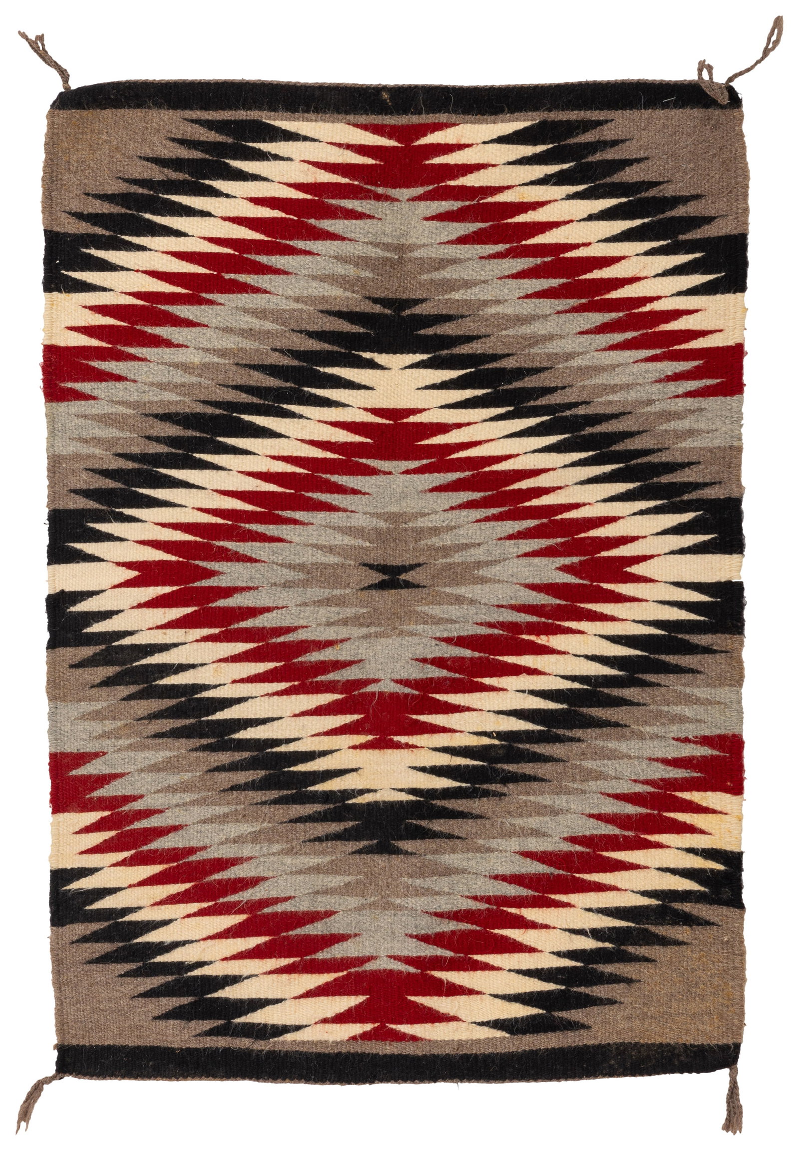 A Navajo regional weaving: A Navajo regional weaving Mid-20th century, Dine Woven in red, cream, grey, brown, and black wool, featuring a central eyedazzler serrated motif 36" H x 26" W