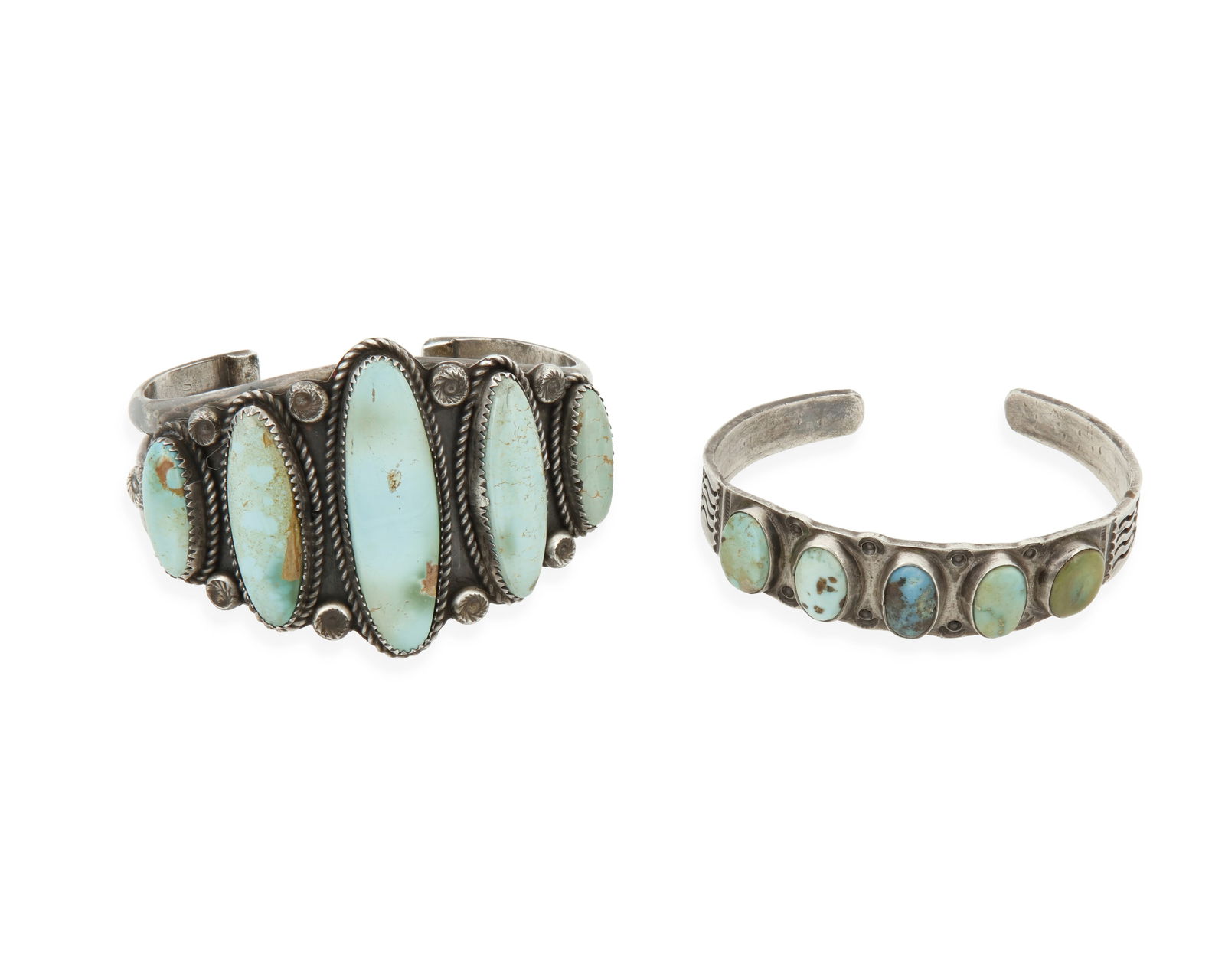 Two Southwest silver and turquoise cuff bracelets: Two Southwest silver and turquoise cuff braceletsMid/late 20th centuryUnmarkedComprising a three-wire cuff with five narrow graduated set turquoise stones, together with a single band narrow cuff with