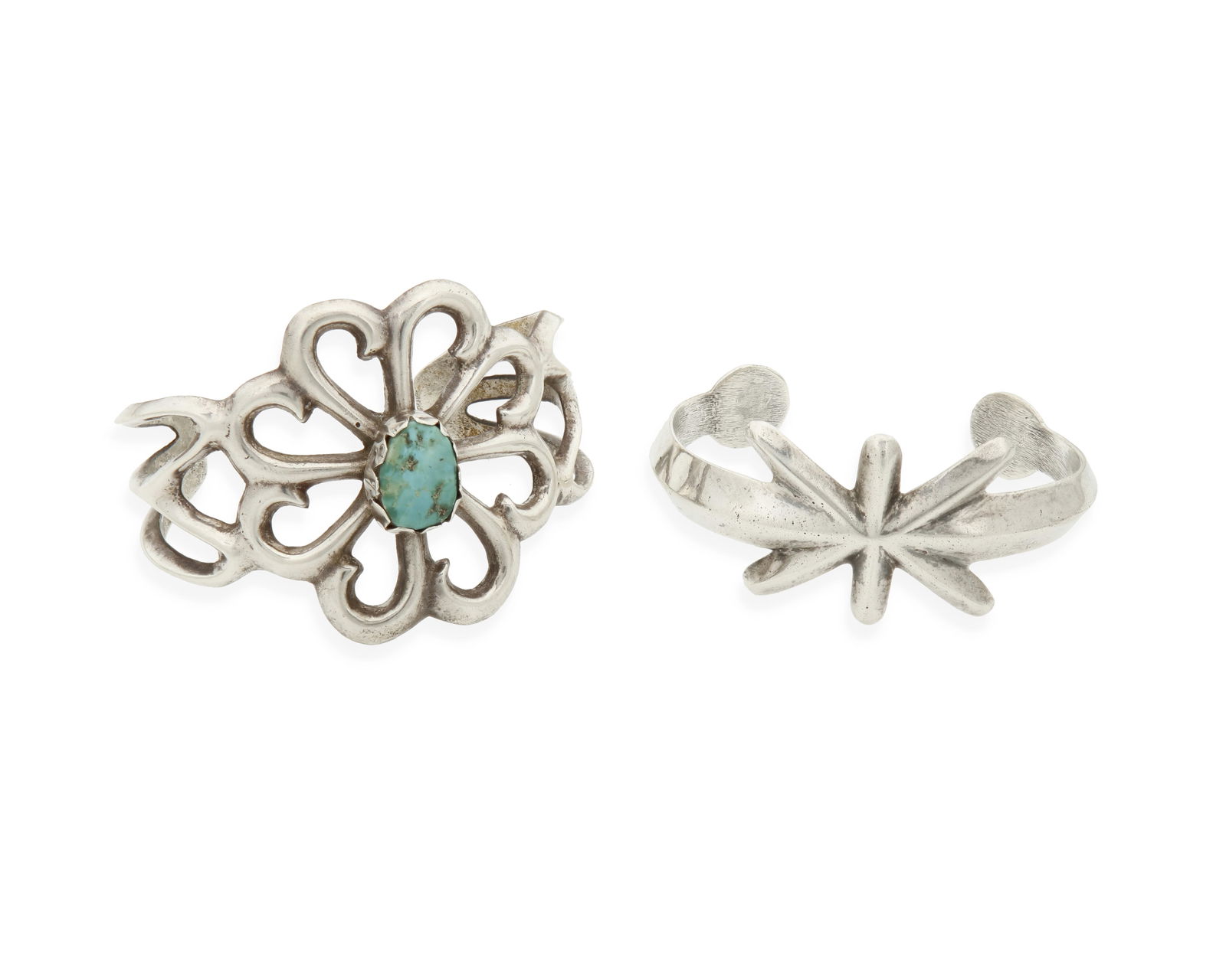 Two Southwest sandcast silver cuff bracelets: Two Southwest sandcast silver cuff braceletsMid/late 20th centuryEach unmarkedComprising a large openwork sandcast cuff with central set turquoise, and a smaller cast cuff with starburst design, 2 pie