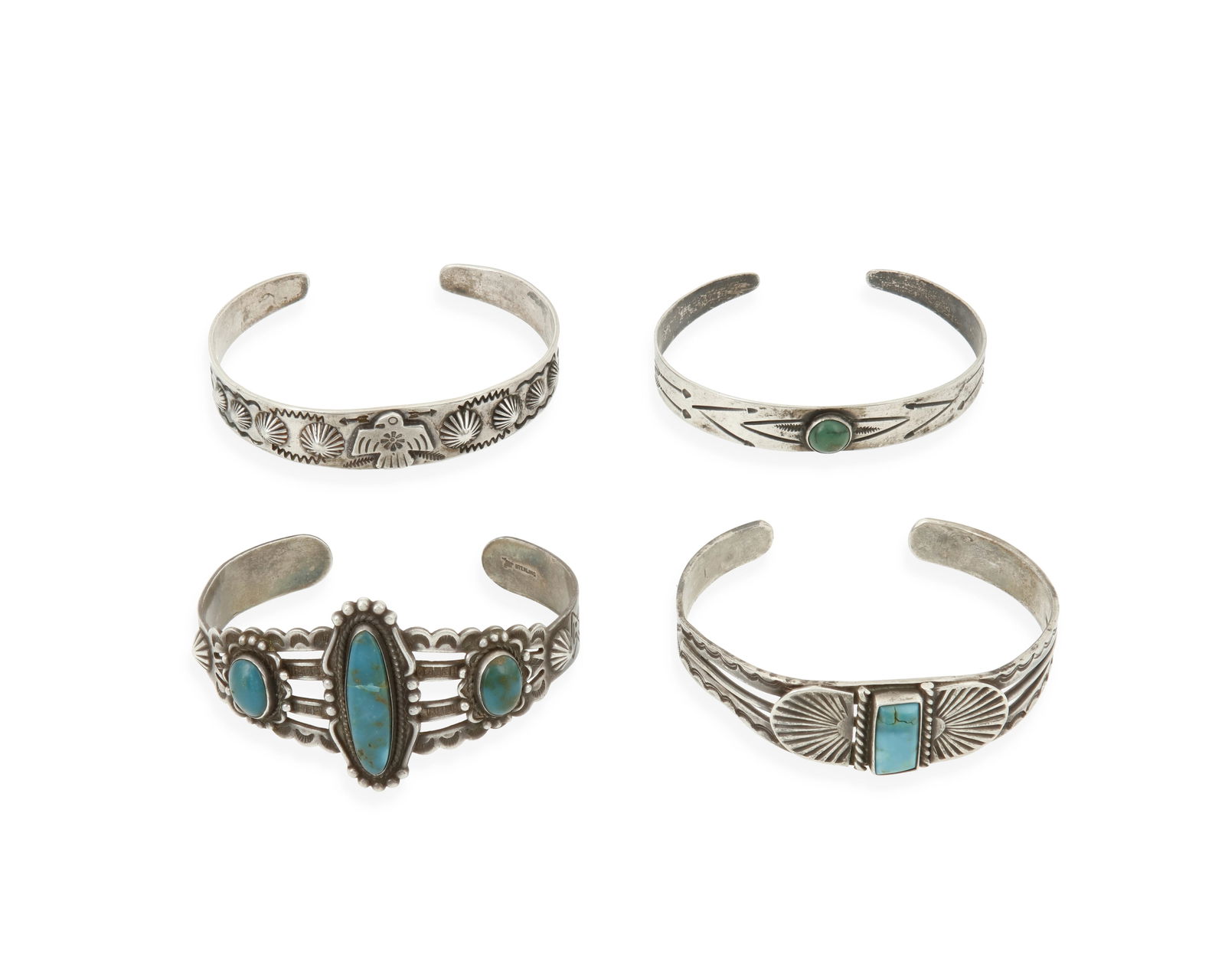 A group of Fred Harvey-style Southwest silver and turquoise cuff bracelets: A group of Fred Harvey-style Southwest silver and turquoise cuff braceletsMid-20th centuryOne marked for Bell Trading Post and for sterlingFour narrow ornate silver and set turquoise cuffs, in various