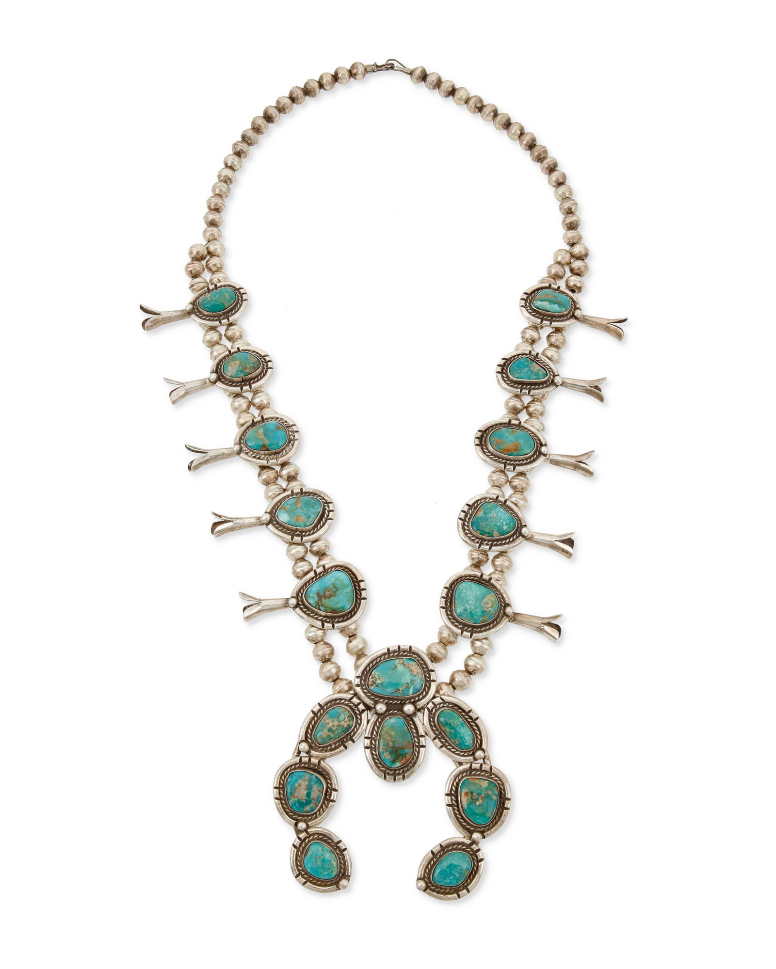 A Southwest silver and turquoise squash blossom necklace: A Southwest silver and turquoise squash blossom necklaceMid/late 20th centuryUnmarkedFeaturing a chunky sterling silver and set turquoise naja with rope wire and silver ball accents with ten matching