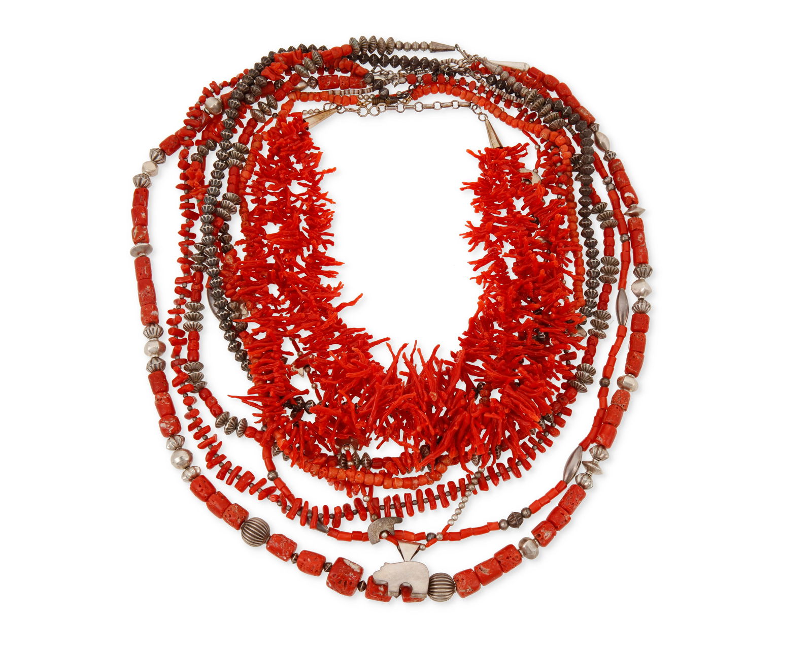 A group of Southwest coral and silver necklaces: A group of Southwest coral and silver necklacesMid/late 20th centuryBear strand stamped: Carlton Jamon / SterlingNine works comprising a Carlton Jamon Zuni (b. 1962) coral bead necklace with sterling
