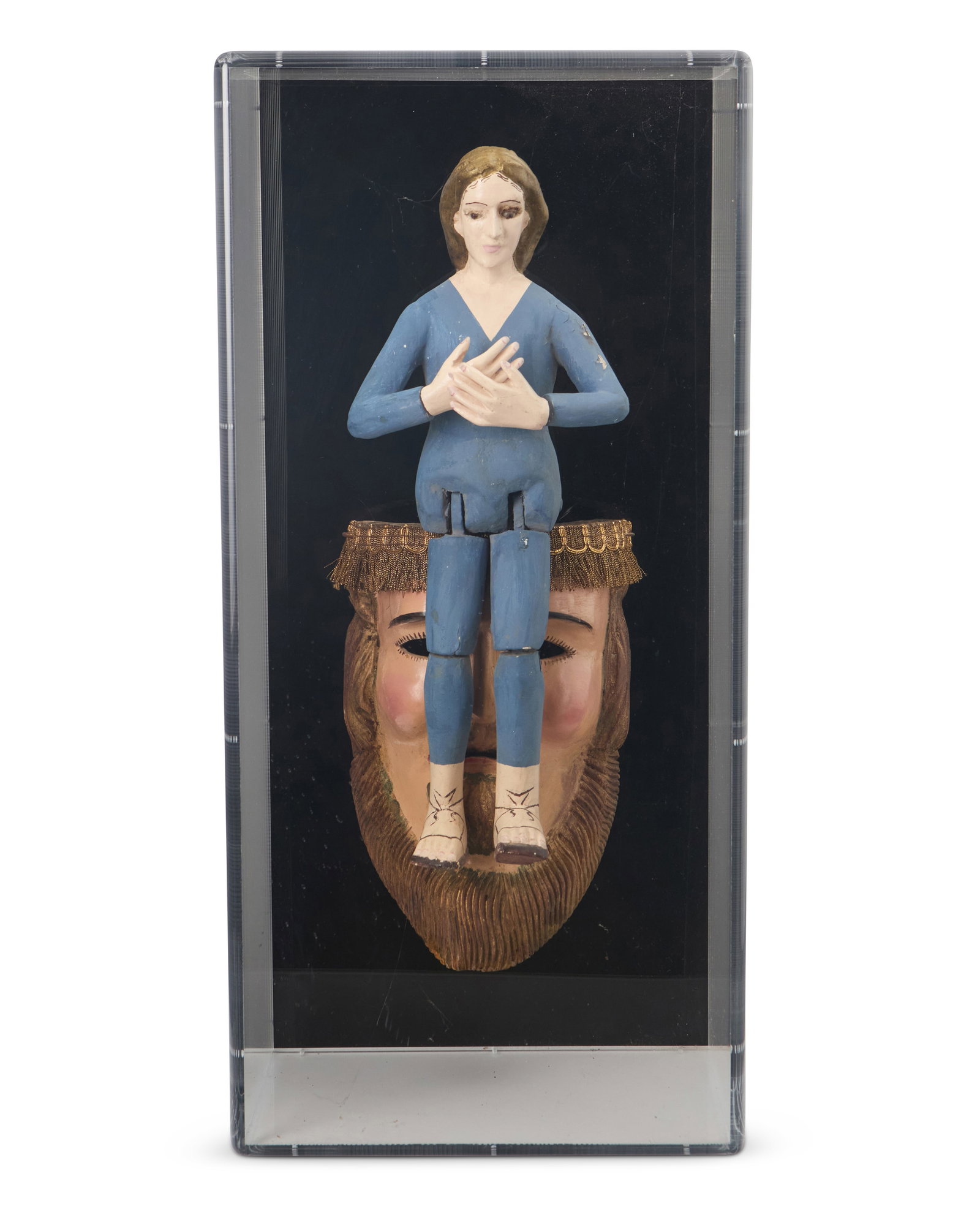 A Latin American santo figure and mask: A Latin American santo figure and mask 20th century Possibly a mask of Jesus Christ, the polychrome and gilt carved wood mask with fabric trim to forehead, mounted at the front with a conforming femal