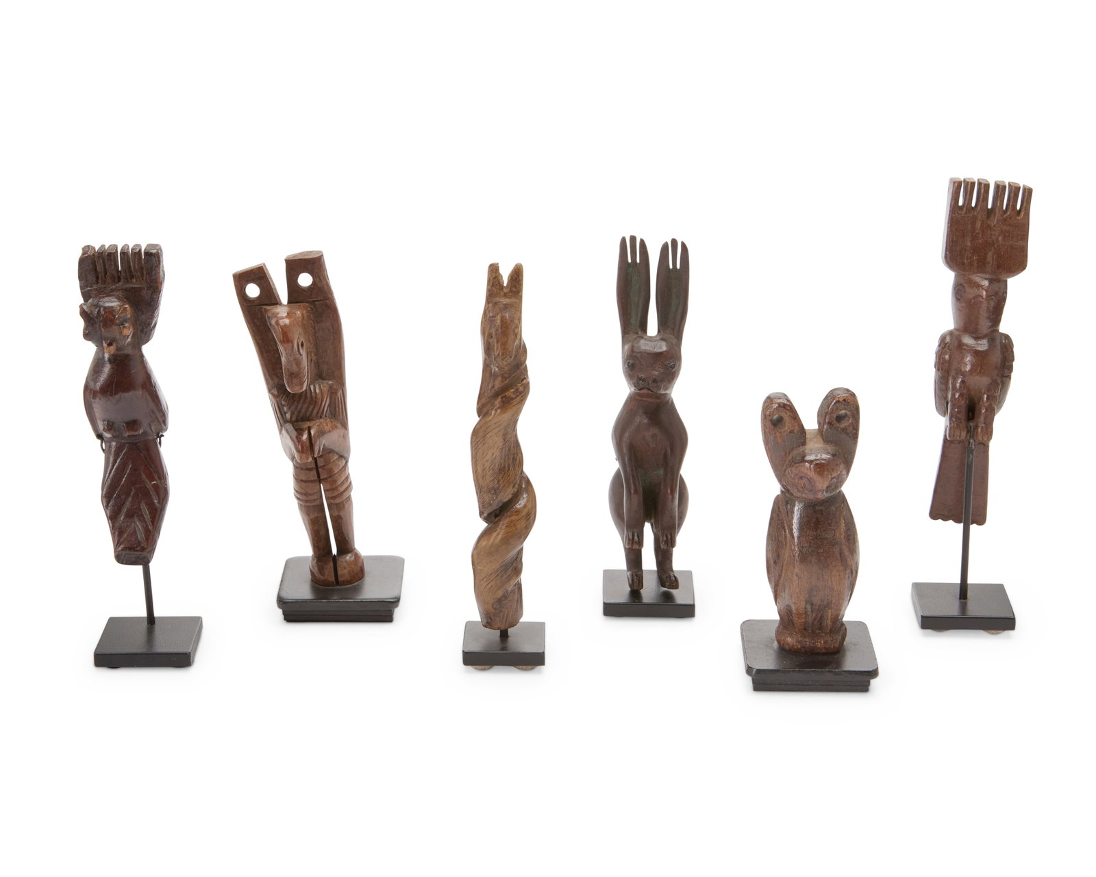 A group of Guatemalan slingshots: A group of Guatemalan slingshots Early 20th century The carved wood figures, each raised on enameled metal stands, comprising two owls, a twisted horse head, a rabbit, a bird, and another animal figur
