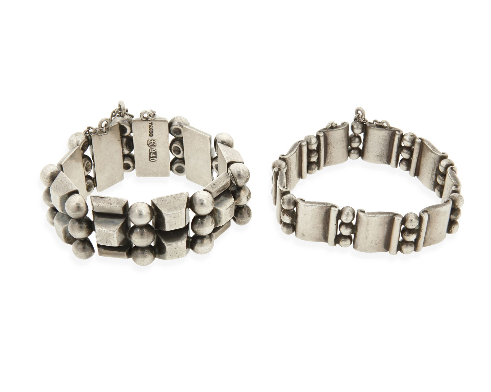 Two Hector Aguilar Mexican silver link bracelets: Two Hector Aguilar Mexican silver link braceletsHector Aguilar (1905-1986)Circa 1940-1948; Taxco, MexicoEach variously stamped: HA [conjoined] / 940 / /990 / TaxcoComprising a narrow "Book and Th