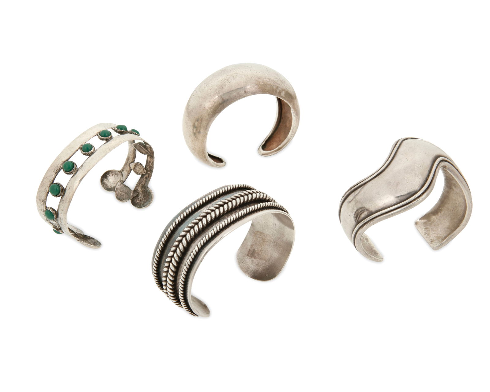 A group of Mexican silver cuff bracelets: A group of Mexican silver cuff braceletsFour works:Antonio Pineda (1919-2009)Circa 1953-1979; Taxco, MexicoWith crown for Antonio Pineda; further stamped: 970 / Silver / Hecho en Mexico / ZZ 661A mode