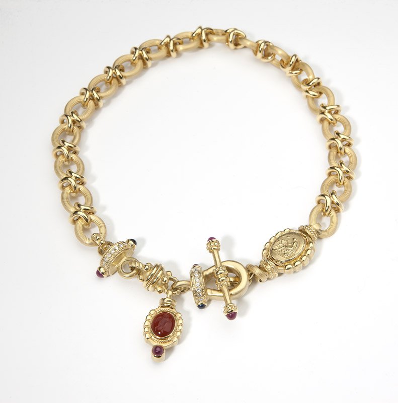 A fancy link gem-set and gold necklace: 18K gold fancy link necklace accented with gem-set cabochons, diamond and carved stone intaglio sectionals, 18.5'', 136.2 gms gross, est:$3500/5500