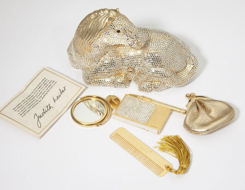 A silver crystal horse minaudiere, Judith Leiber: Each item signed Judith Leiber; silver crystal horse minaudiere comes with a coinpurse, mirror, and comb; miniature notebook with goldtone pen (approx 2.25'' H x 1.25 W x .25 D); accompanied with two